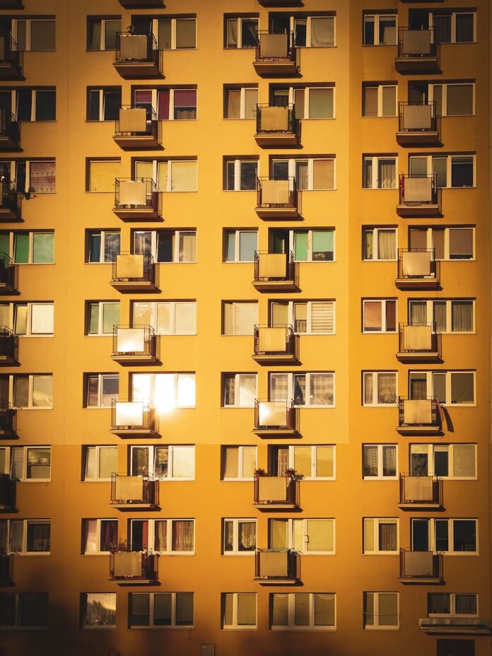 Sunlit facade of a modern apartment building in Gdańsk, Poland. Captures the architectural design and urban living.